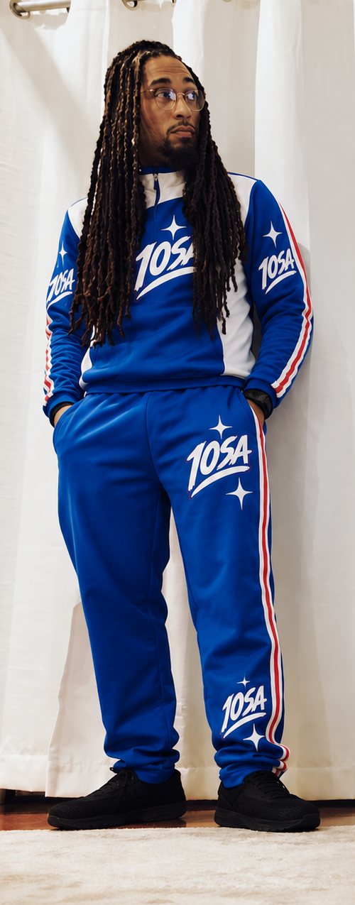 Young G Ball in the blue 10SA tracksuit, looking over at the TV